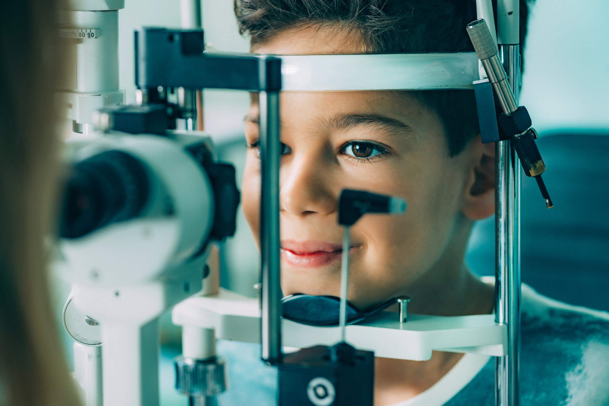 young boy at optometrist, receiving a visual field test