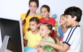 Group of children in front of a computer