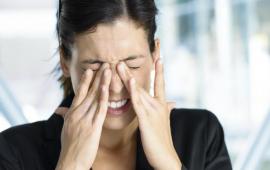 Woman rubbing her dry eyes