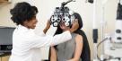 Optometrist giving a young woman an eye exam