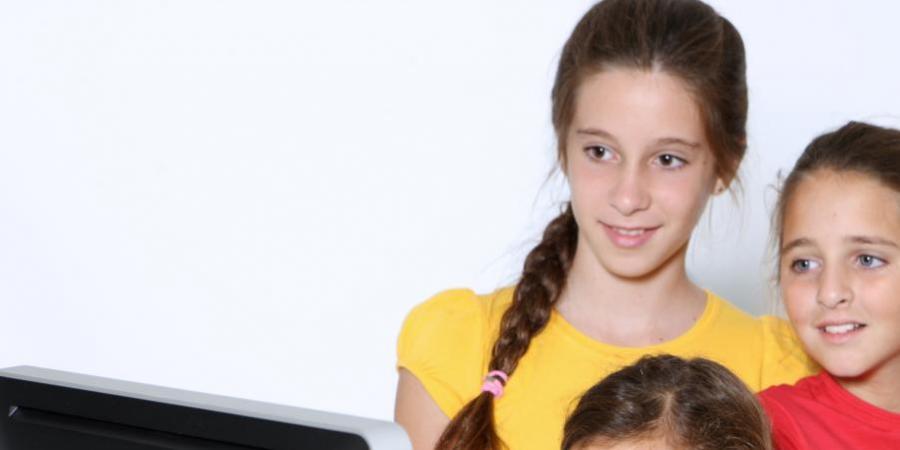 Group of children in front of a screen