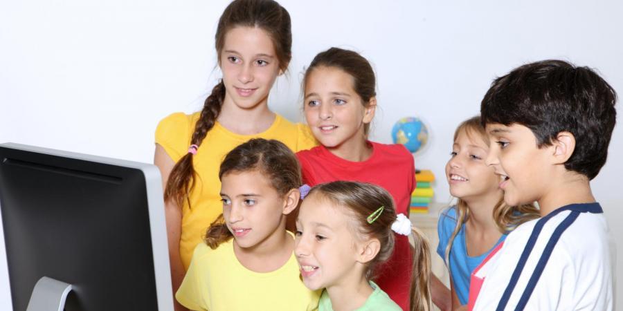 children in front of a computer