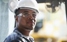 Young man wearing helmet and safety glasses